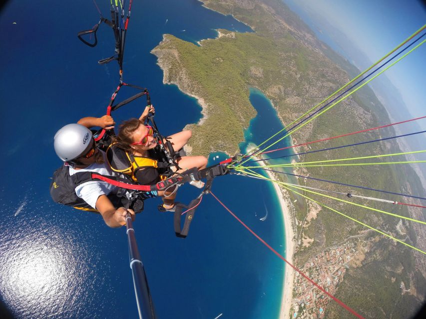 Fethiye: Tandem Paragliding Experience w/Hotel Pickup - Floating over Oludeniz, Blue Lagoon color, and coastline shapes