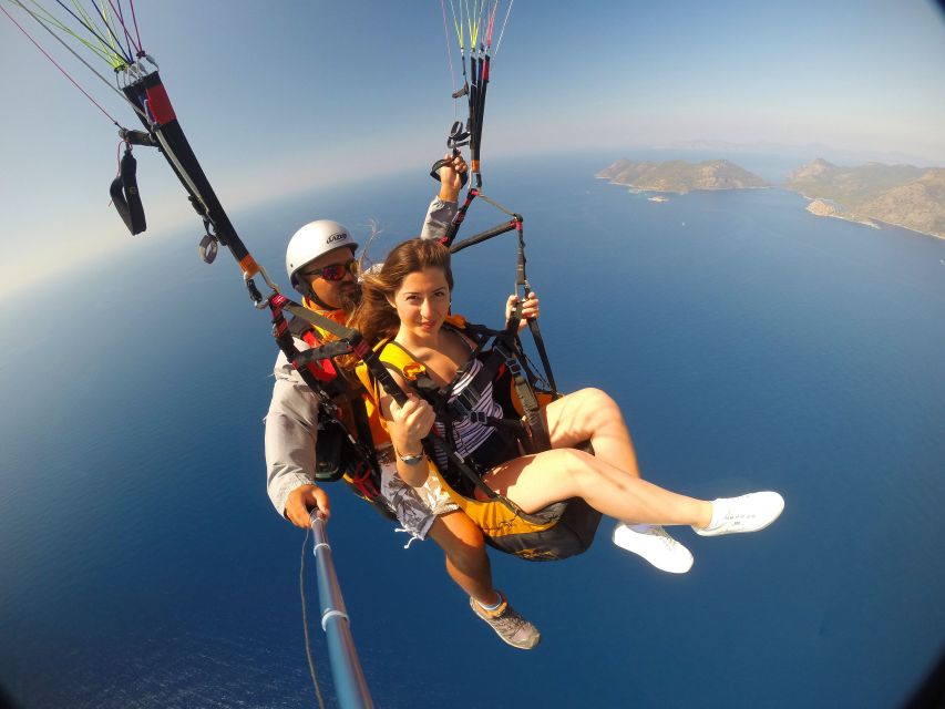 Fethiye: Tandem Paragliding Experience w/Hotel Pickup - Landing on sand, then dealing with photos